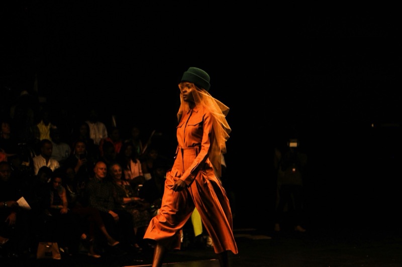 Example image: a model under a spotlight on the runway