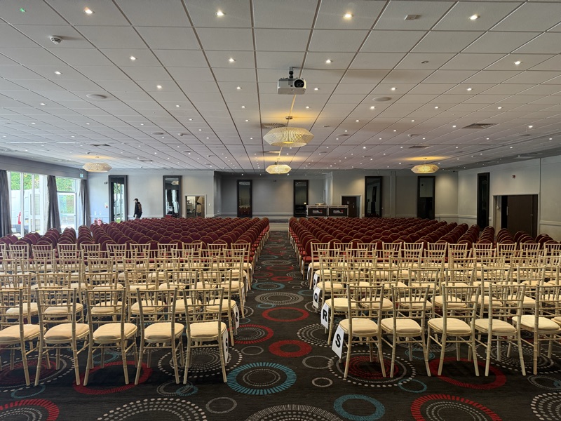 Function room set up with a screen and seating before an event