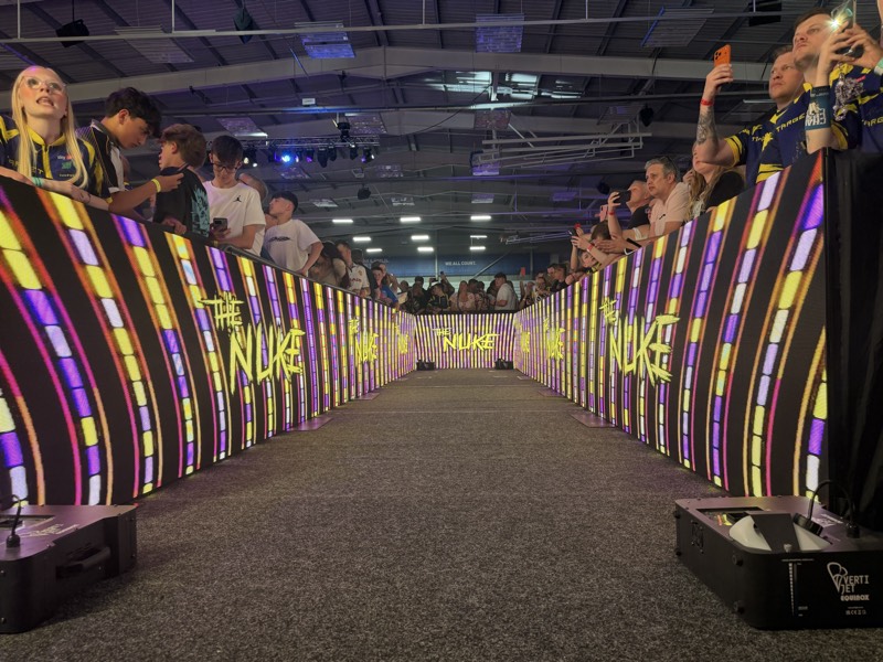 Fans lining an LED entrance walkway displaying The Nuke graphics