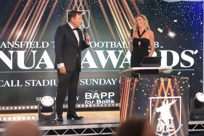 Presenters on stage at the Mansfield Town FC Annual Awards in front of an LED backdrop