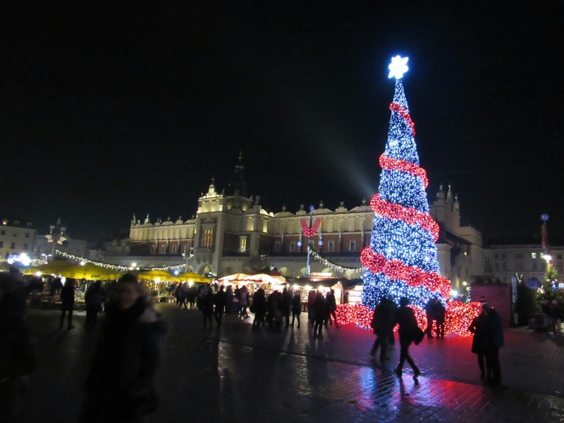 Example image: a lit Christmas tree in a town square at night